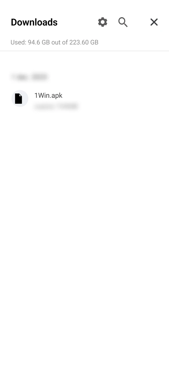 Find the 1Win APK in your phone's downloads folder.